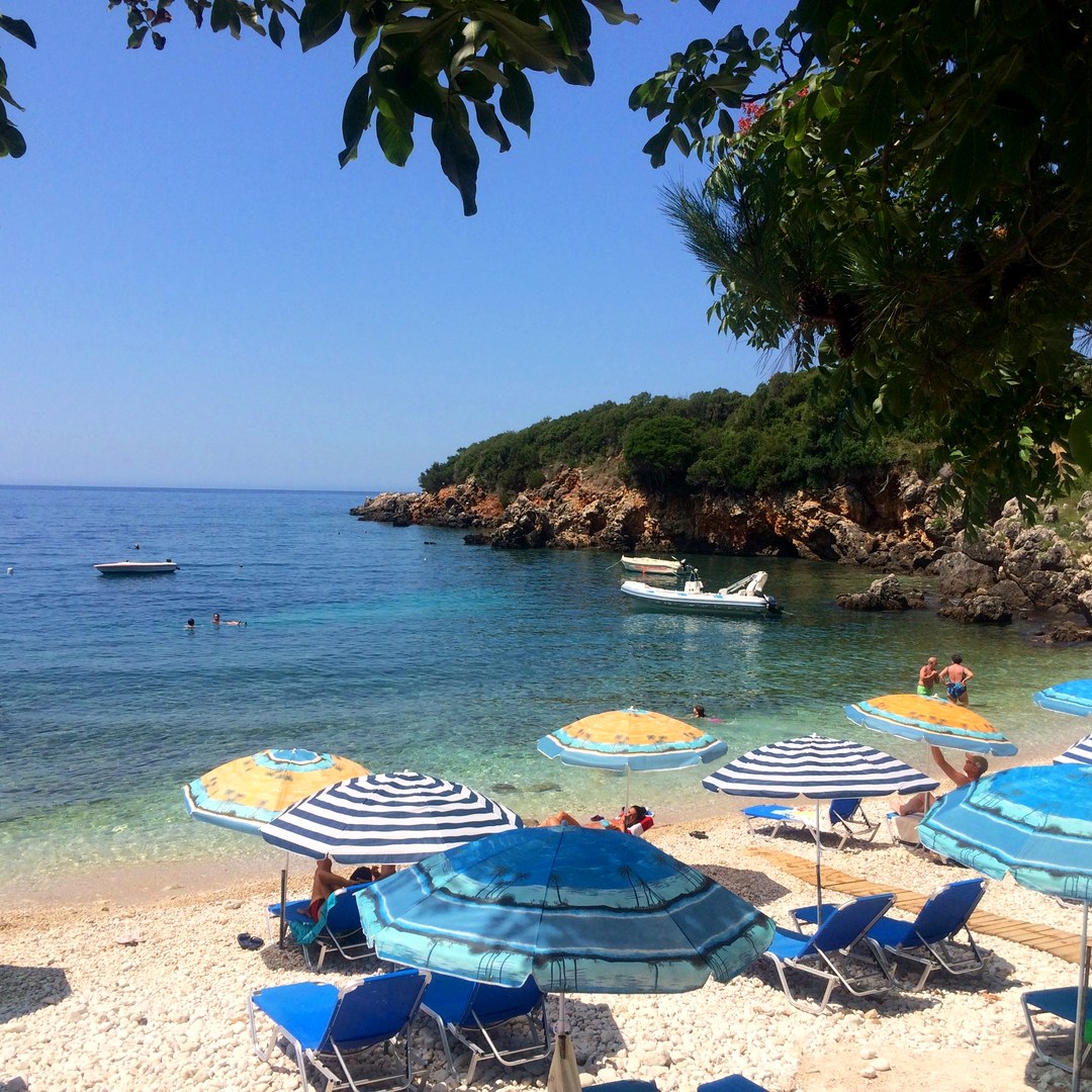Beach umbrellas in rocky cove