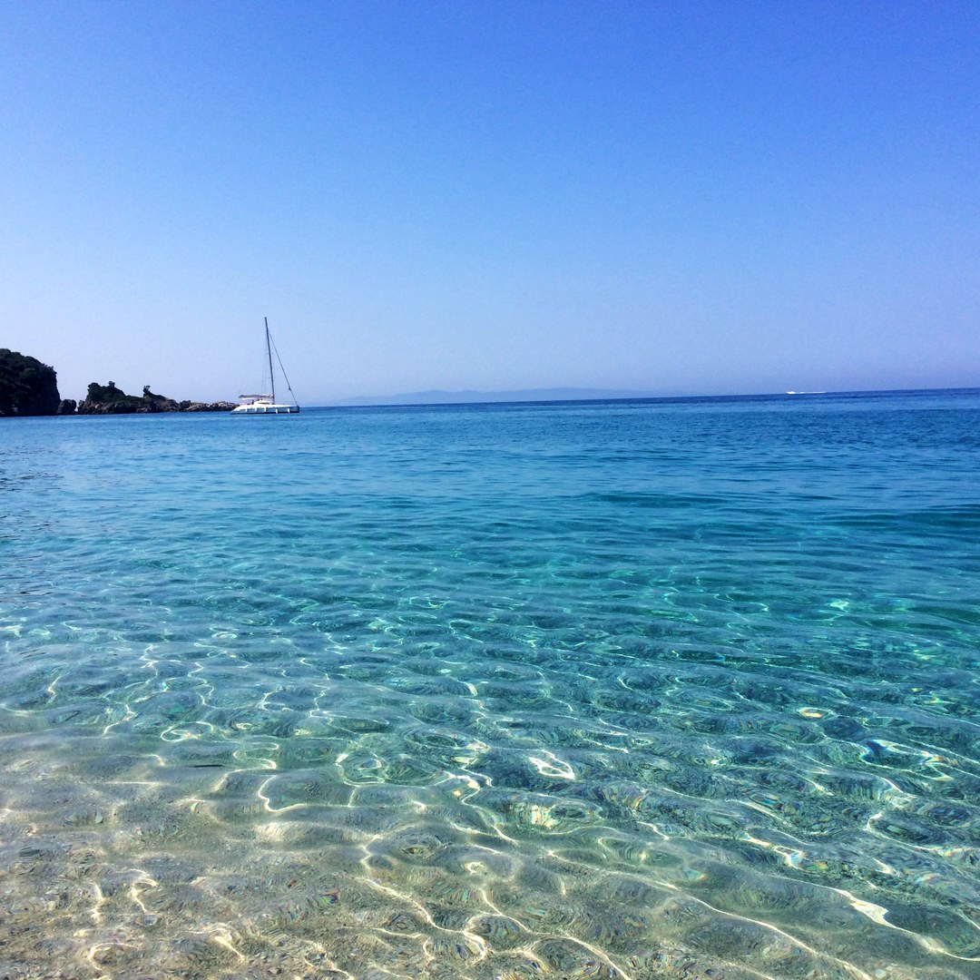Crystal clear water with sailboat