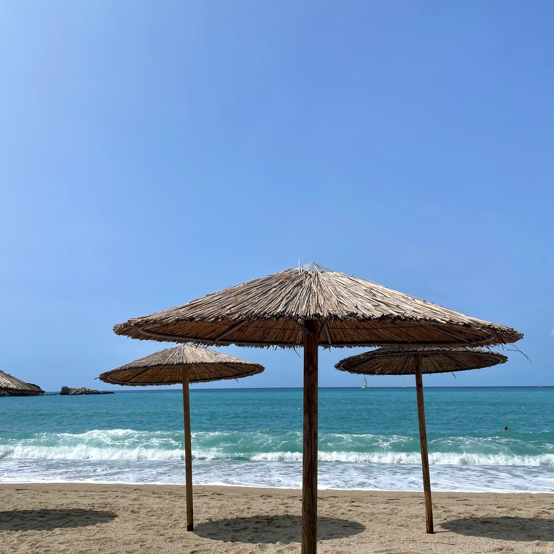 Straw umbrellas and sun loungers